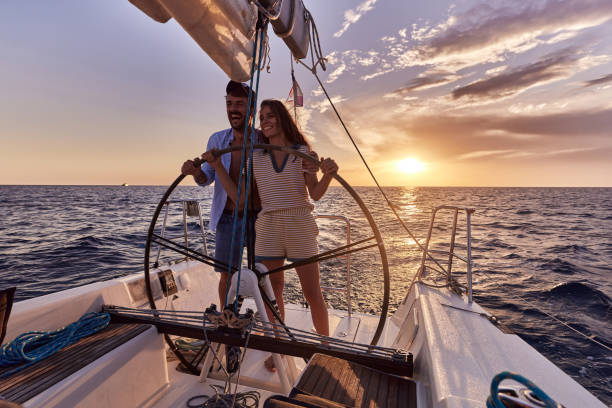 istock Happy couple having fun while driving a boat at sunset. 1461553997