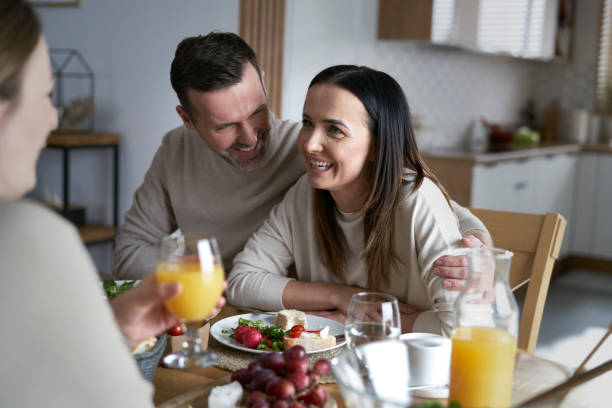 istock Couple enjoying lunch with friends at home 1461554071