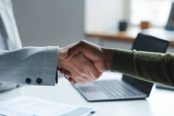 istock Business partners shaking hands at table 1461554651