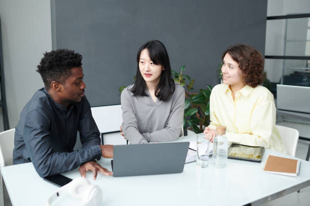 istock Colleagues working on laptop at meeting 1461555728