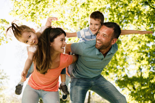 istock Playful family having fun while piggybacking in nature. 1461556447