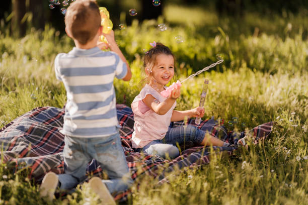 istock Playful little siblings having fun during spring day in nature. 1461556650