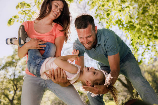 istock Happy parents having fun with their girl in springtime. 1461556824