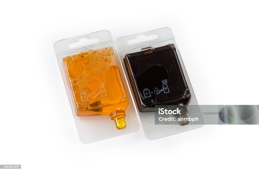 Two concentrates of the cleaning agents in plastic trade packings Different liquid concentrates of the cleaning agents in two small plastic bottles in the trade packings on a white background Backgrounds Stock Photo