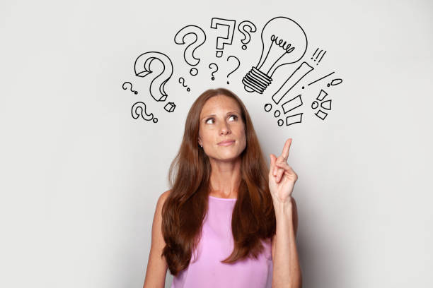 istock Pensive brunette woman with light bulbs and question marks above her head. Idea, brainstorming, business stratgy, thinking concept 1461558841