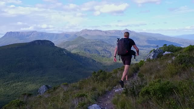 Young man hiking in the mountains of Tasmania in good weather