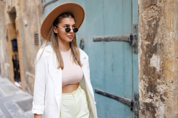 istock Stylish young woman walking down the street 1461559901