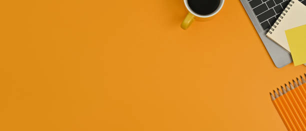 istock Laptop computer, notepad and coffee cup on yellow background. Copy space for your advertise text. 1461562637