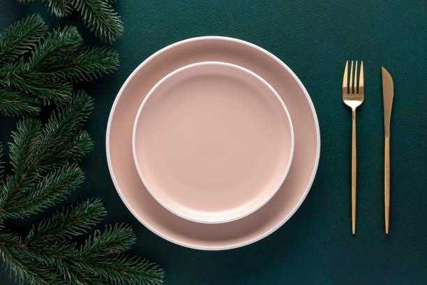 istock Empty beige plates on a dark green background. Top view. Card or menu template, flat design. Tableware, crockery. Aerial view, copy space. Christmas table setting with New Year decorations. 1461563746