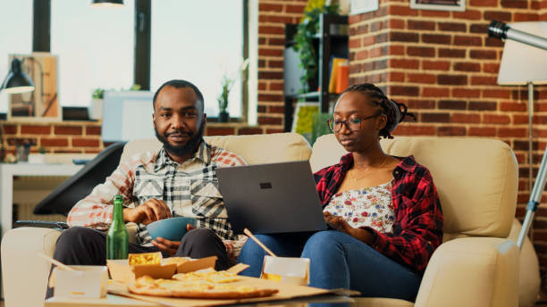 istock Young people in relationship watching tv show at home 1461564671