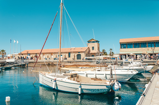 The port of Paphos in spring. Boats and ships are docked in the port.