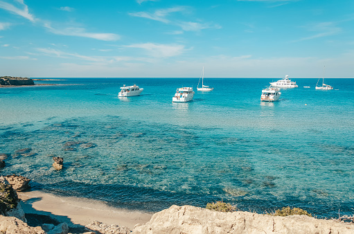Tourist boats are mooring at Blue lagoon at Akamas peninsula on Cyprus