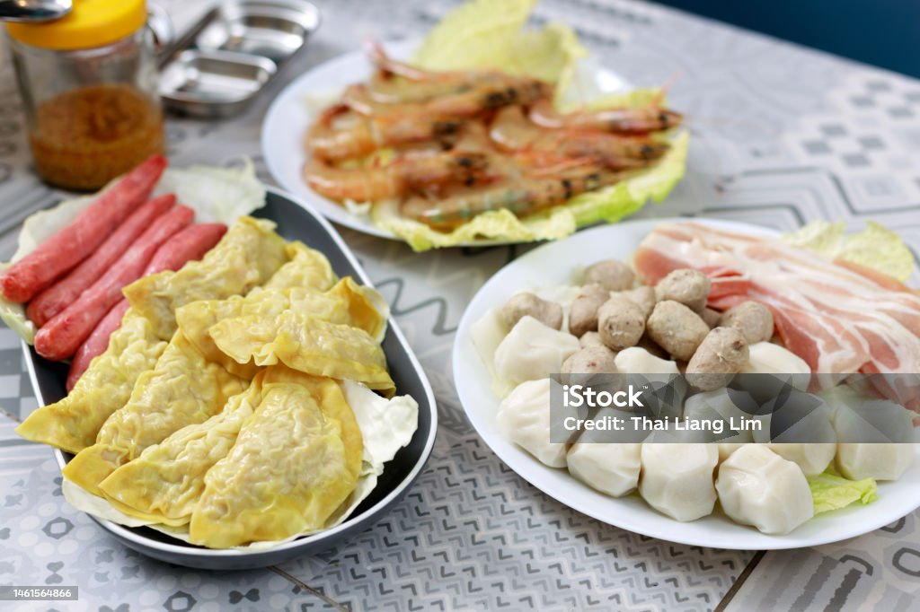 Hot pot dish, steamboat buffet ingredient Hot pot, also known as steamboat, popular East Asian food, prepared with a simmering pot of stock at the dining table. Asian Food Stock Photo