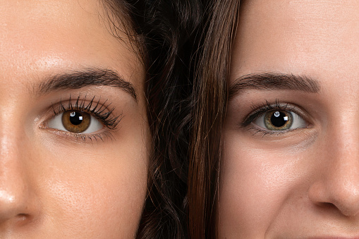 Portrait of two girls with face in contact. Half face in comparison. Concept of beauty, health and youth