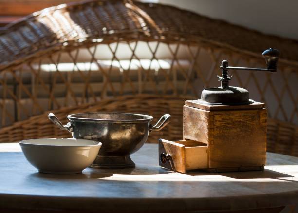 istock Vintage coffee mill on wooden table and sunlight 1461566255