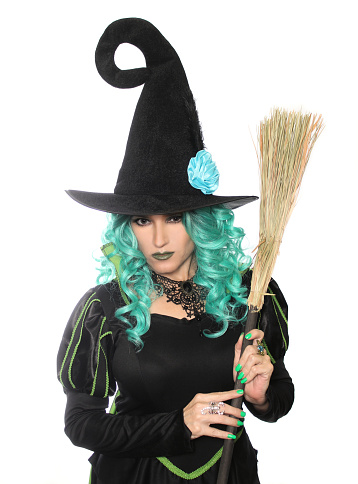 A vertical closeup shot of the witch holding a broom isolated on the white background