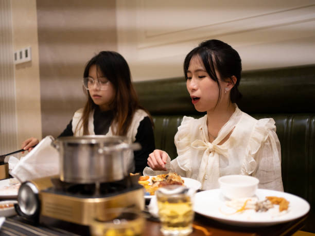 istock girl eating hot pot 1461569366
