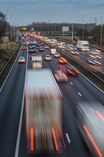 Long exposure photography of fast moving traffic speeding along the M42 motorway during the evening rush hour.