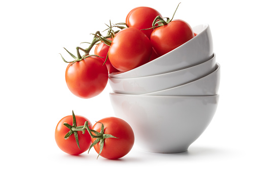 Cherry tomatoes in a wooden bowl isolated on white background