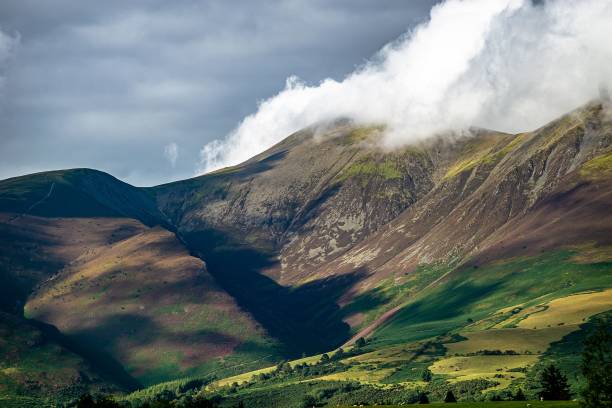 istock Scenic view of mountains with cloudy sky in background 1461569661