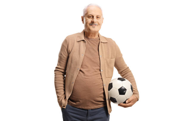 istock Elderly man holding a football 1461569821