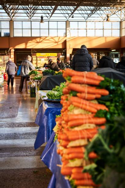 istock Fresh carrots and celery roots wrapped together, on a market stall . 1461569998