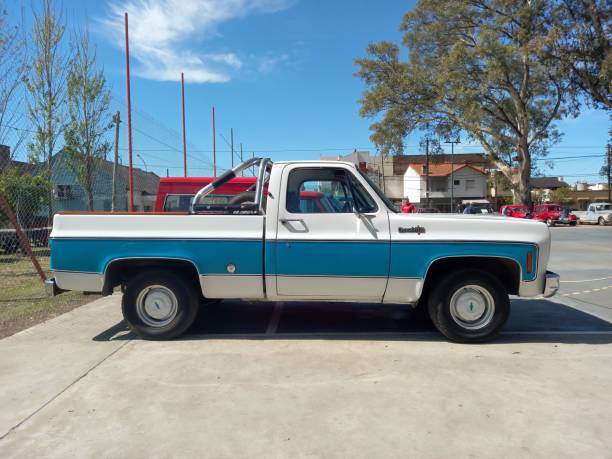 old 1970s Chevrolet Chevy C 10 Rounded Line pickup truck Fleetside bed. AAA 2022 Classic car show. Lanus, Argentina – September 25, 2022: old white and blue 1970s Chevrolet Chevy C 10 Rounded Line pickup truck Fleetside bed by GM in a park. AAA 2022 Classic car show. Chevrolet stock pictures, royalty-free photos & images