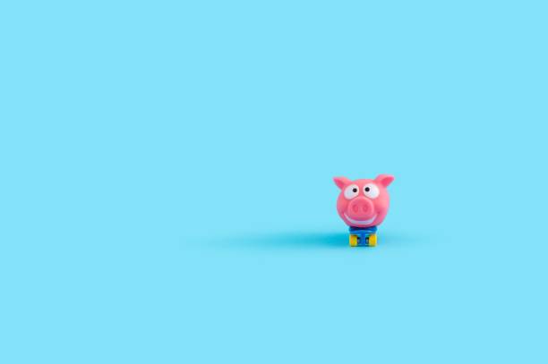 istock Small piggy toy isolated on a blue background 1461571203