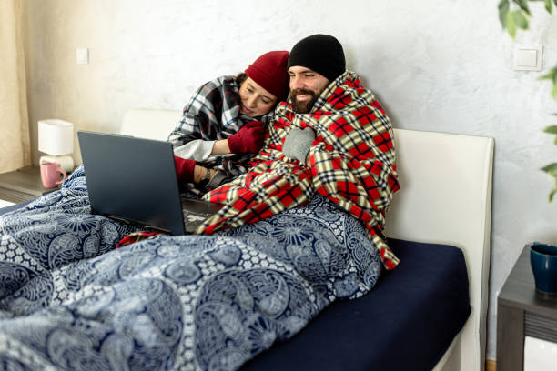 istock A young couple is suffering from a cold temperature during an energetic crisis and trying to warm up in a bedroom. 1461576809