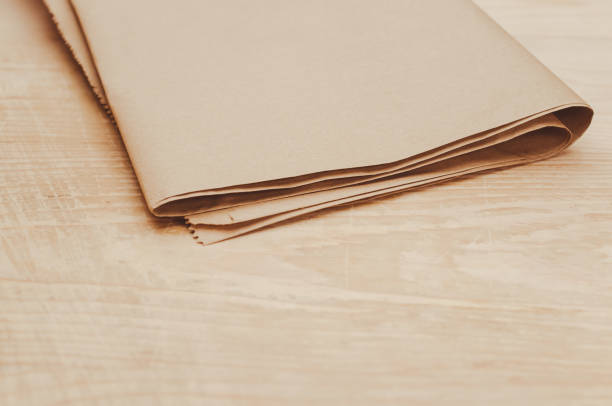 istock folded brown paper on a rustic wooden background with space for text 1461576995