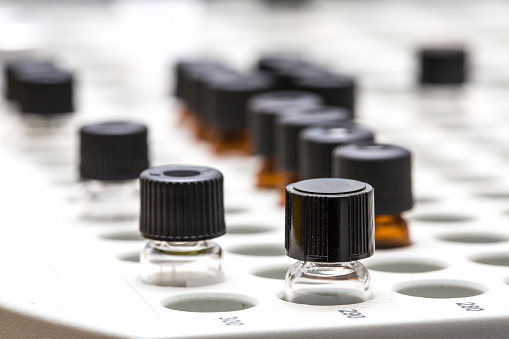 Small bottles containing laboratory samples ready to be analyzed with state-of-the-art instrumentation