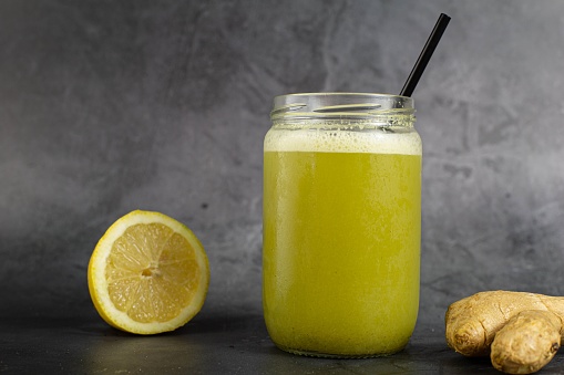 A closeup shot of a healthy juice with lemon and ginger