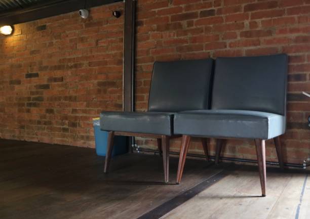 istock Decorative grey chair on brick wall background and wooden floor. 1461579944