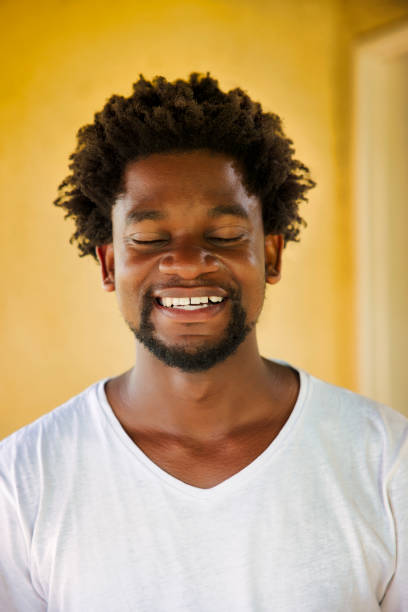 istock happy african young man with closed eyes 1461580928