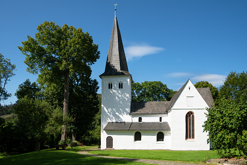 A beautiful view of the Medieval church of Wiedenest surrounded by trees in Germany