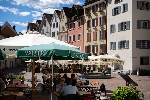 Chur, Switzerland – August 21, 2022: A cozy corner of cafes with tourist sights in Grisons Chur City, Switzerland