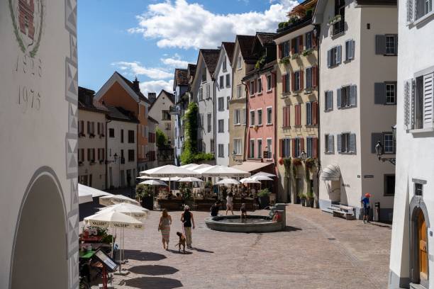 closeup of people walking near the buildings in chur, grisons, switzerland - chur imagens e fotografias de stock