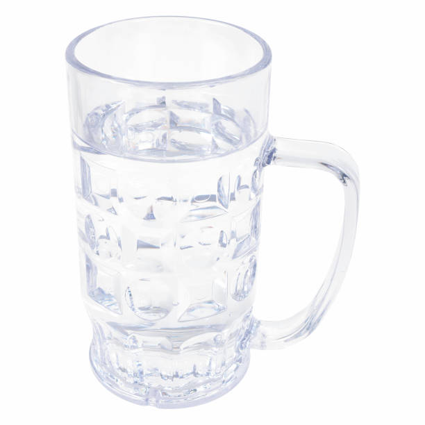 Closeup of a big glass mug filled with water isolated on the white background A closeup of a big glass mug filled with water isolated on the white background large german beer steins stock pictures, royalty-free photos & images