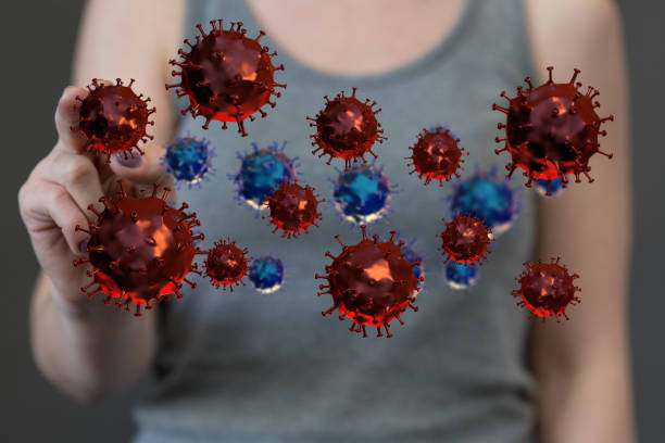 istock 3D rendered abstract Covid cells tapped by a female hand 1461583644
