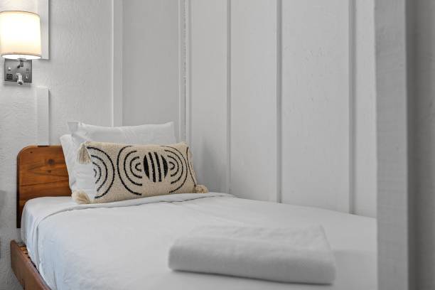 istock White interior of the room with bed, pillows and lights. 1461584042