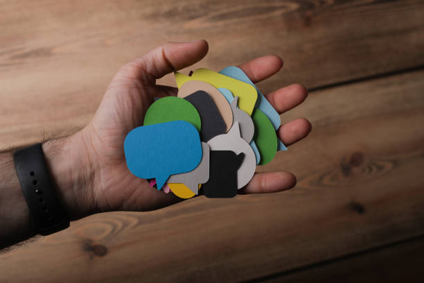 istock Top view of speech bubble icons in a person's hand 1461584866