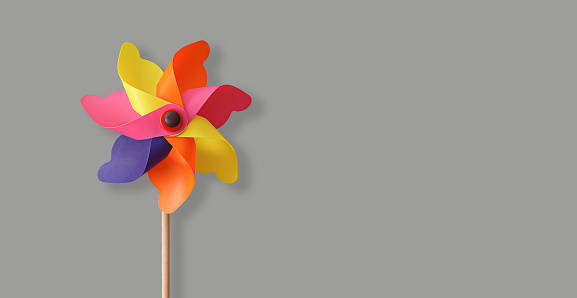 Colorful pinwheel isolated on the gray background with copy space