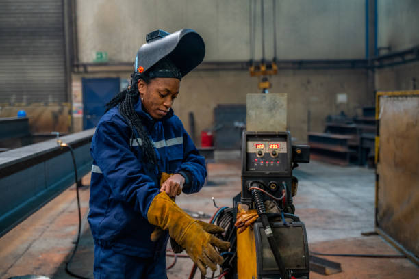 Team of engineers with safety suits and helmet working at the factory