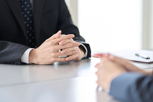 A man in a managerial position interviewing an employee