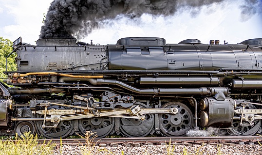 Train is moving on tracks with steam and smoke