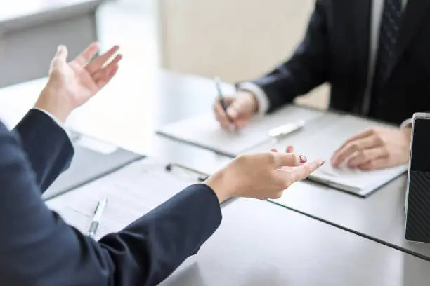 Photo of Hand of a business woman giving an explanation at a meeting