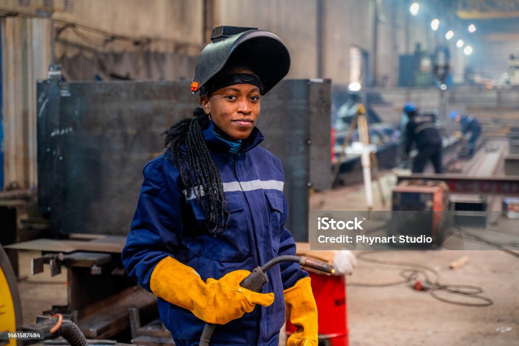 Young  Woman Welding A young university student female is practicing her welding skills Welder Stock Photo