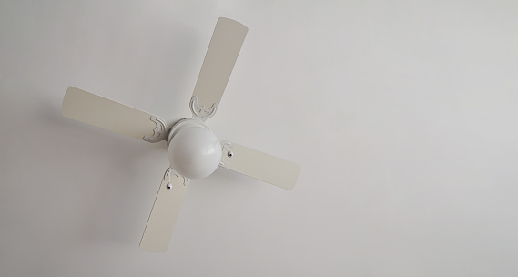 Electric ceiling lamp with propeller, electric installation services, with white ceiling, copy space