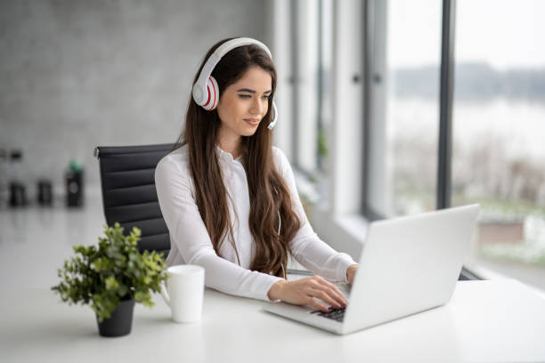 istock Young beautiful woman agent working on laptop using headset with microphone in bright modern office. 1461589823
