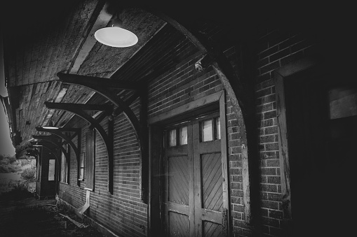 Grayscale shot of an abandoned train station